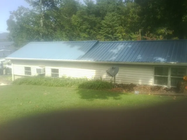 Blue metal roof running the length of a single story home in Mount Sherman
